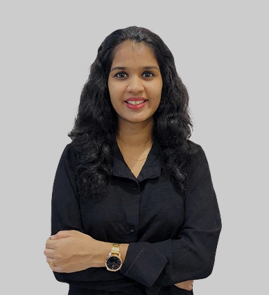 Best digital marketing strategist in Riyadh standing confidently with arms crossed, wearing a black outfit and smiling against a plain black background.